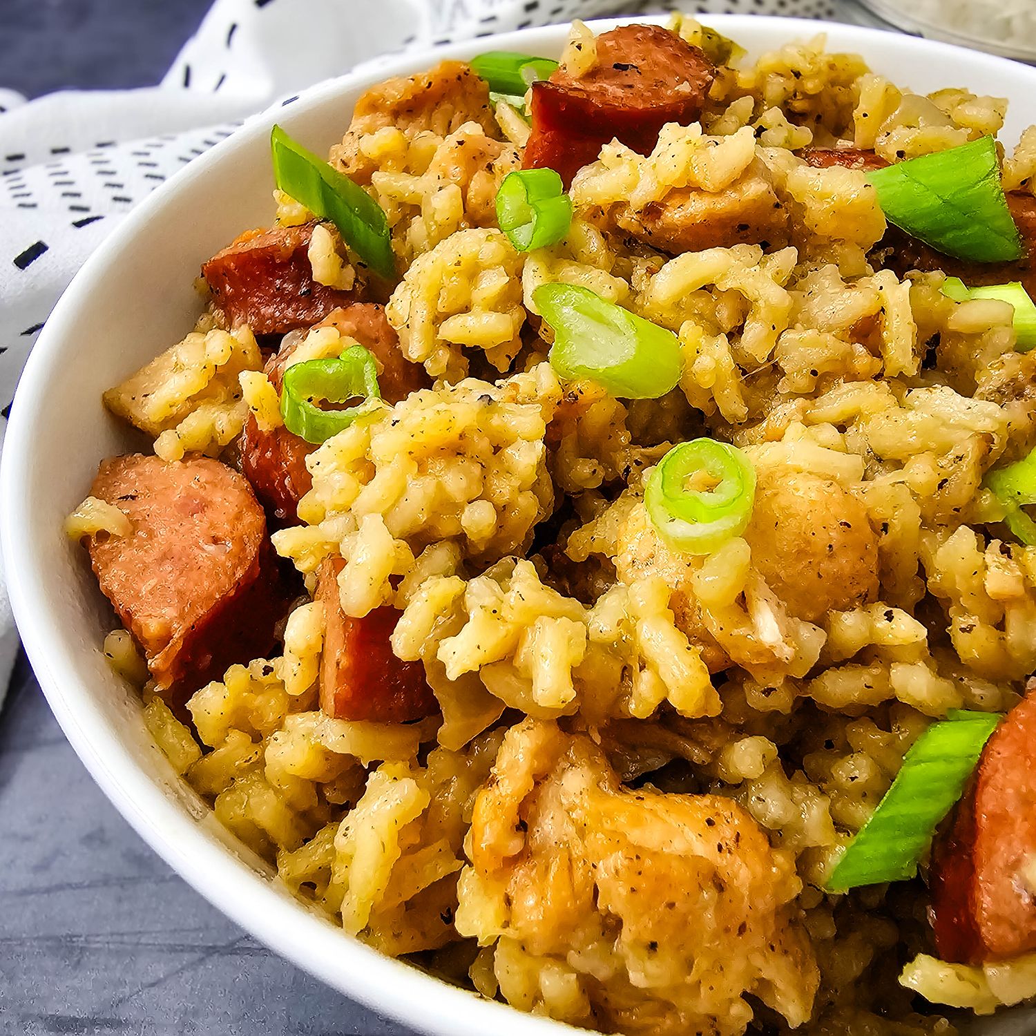 Closeup of brown jambalaya (no tomatoes) in a white bowl