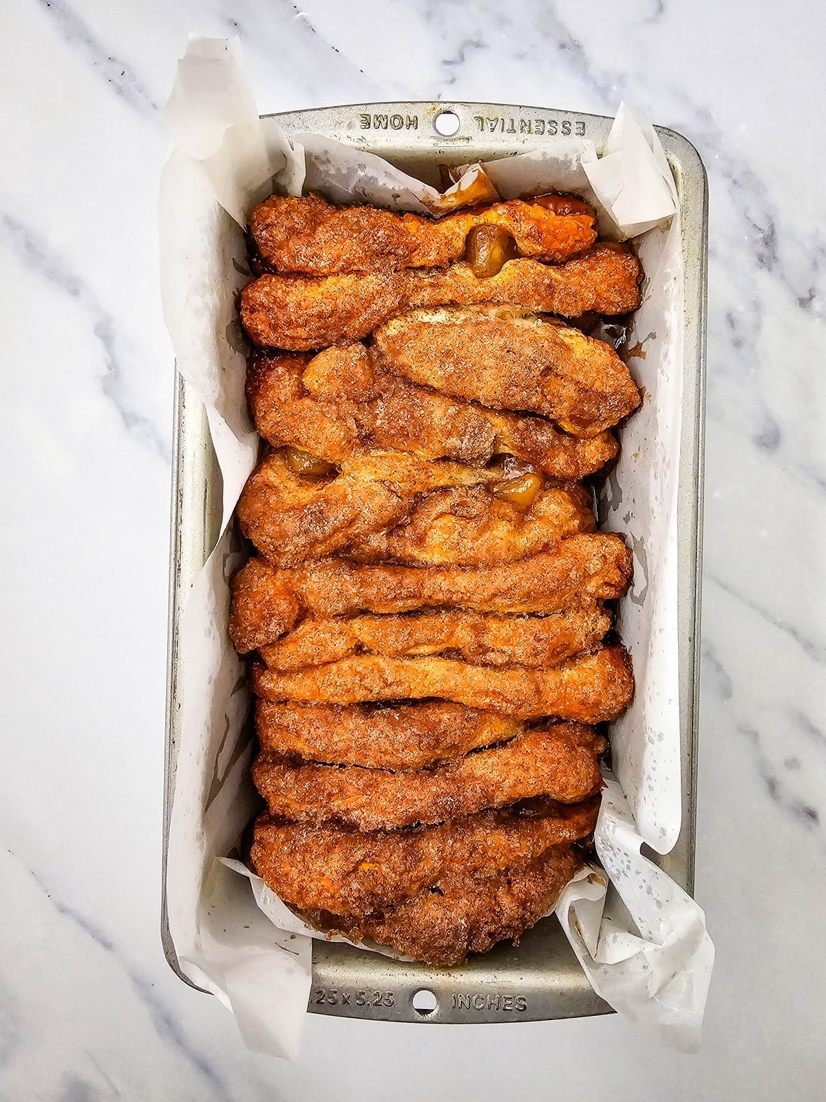 Baked apple cinnamon biscuit loaf with deeply browned cinnamon sugar top