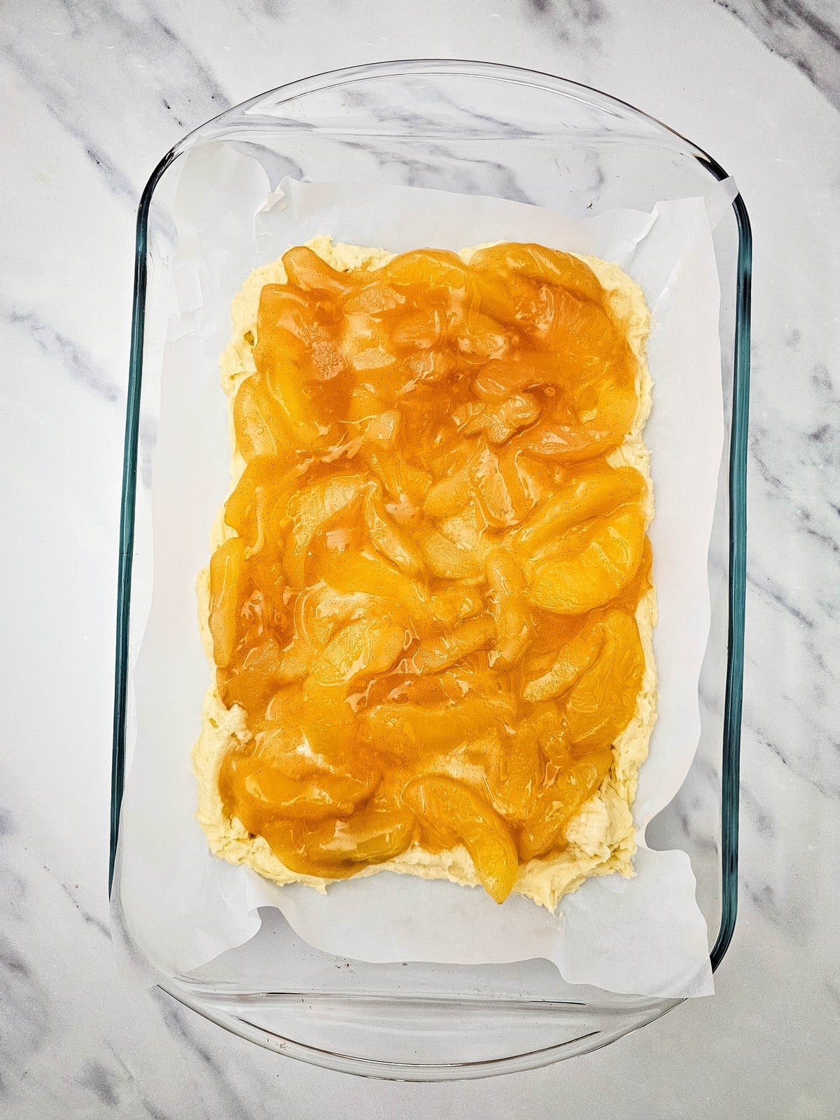 Apple pie filling spooned over the coffee cake batter