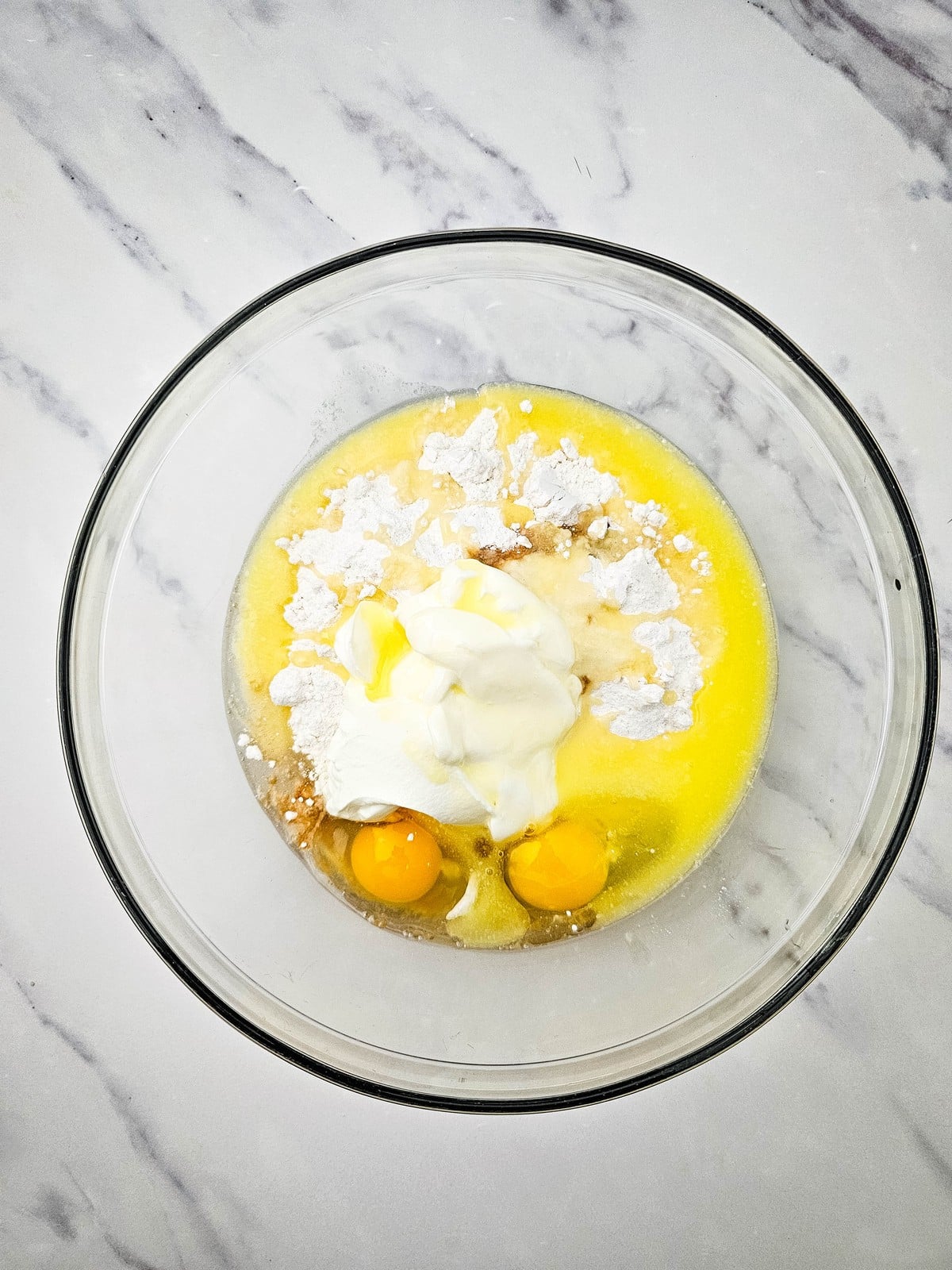 Cake mix, eggs and sour cream in a bowl for the coffee cake batter