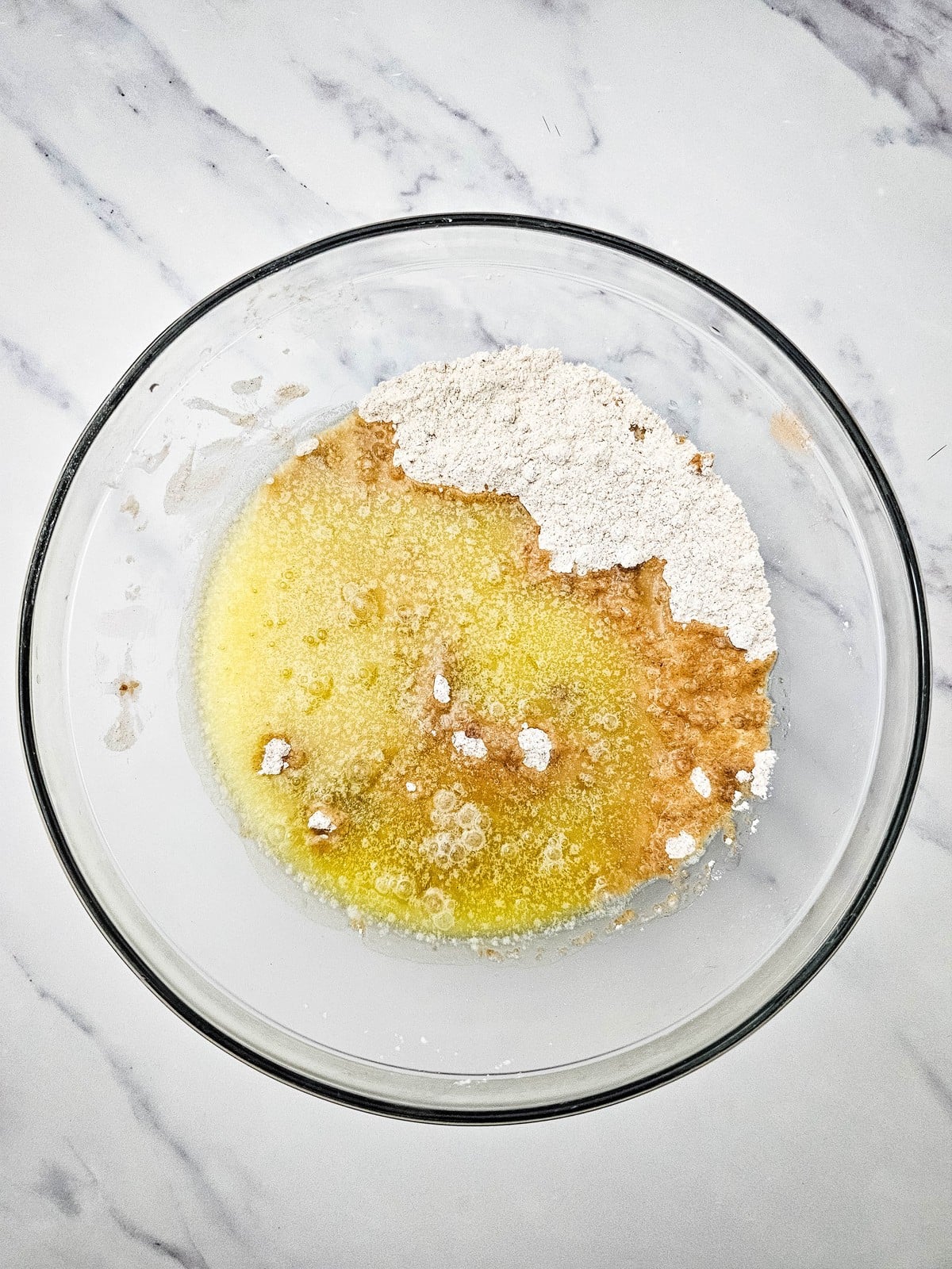 Melted butter poured into the dry crumble mixture