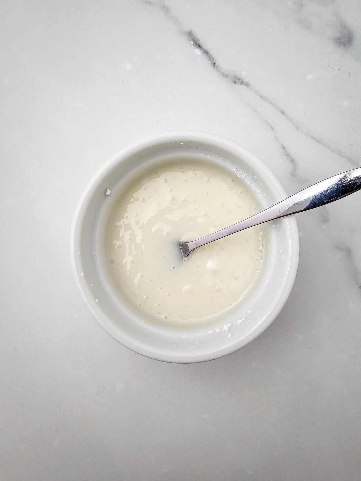 Powdered sugar glaze in a small bowl