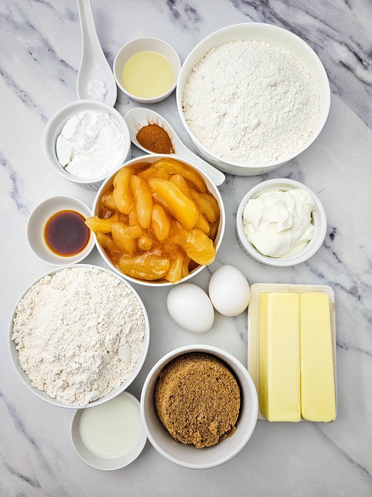 Ingredients for apple coffee cake including cake mix, apple pie filling, flour, brown sugar and butter