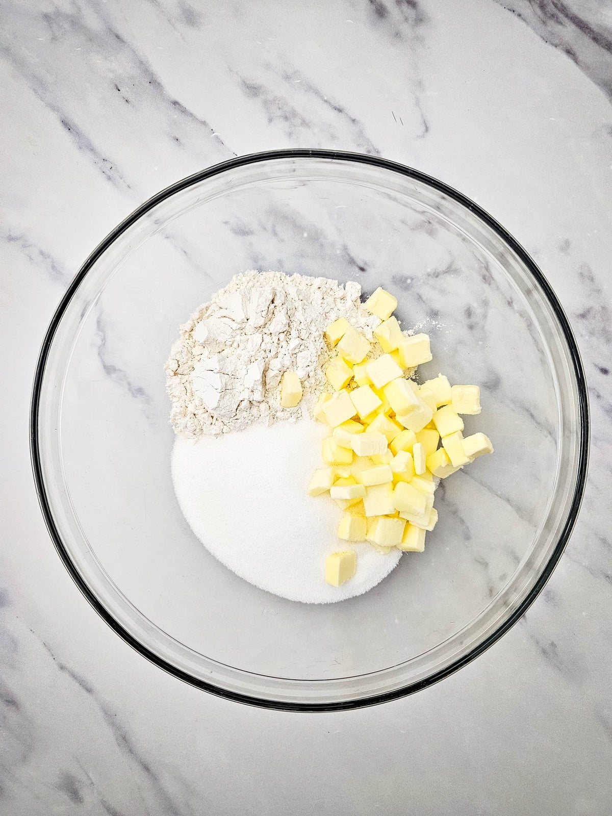 Flour, sugar and cubed butter in a glass bowl for the crumble topping