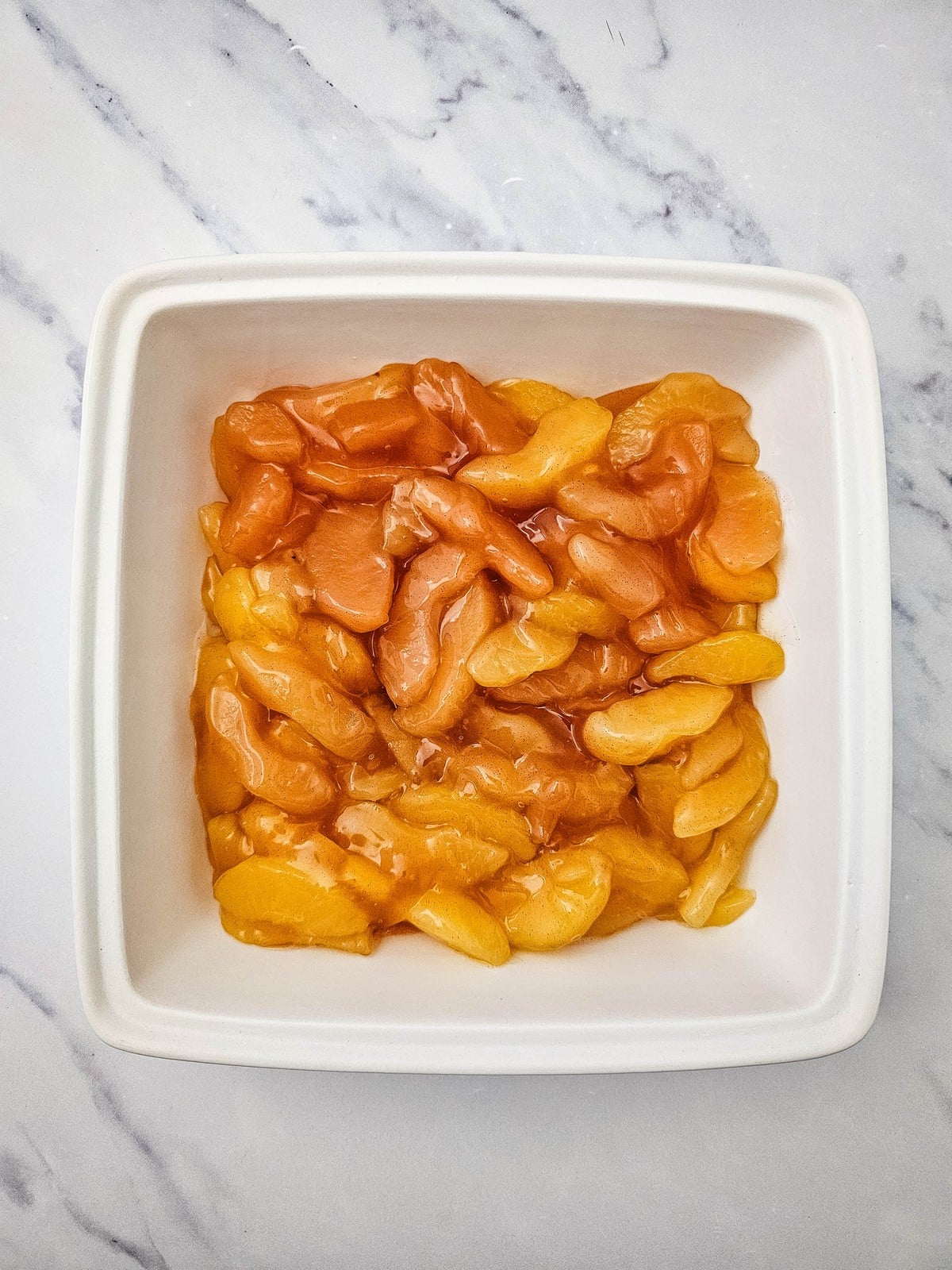 Apple pie filling poured into a baking dish