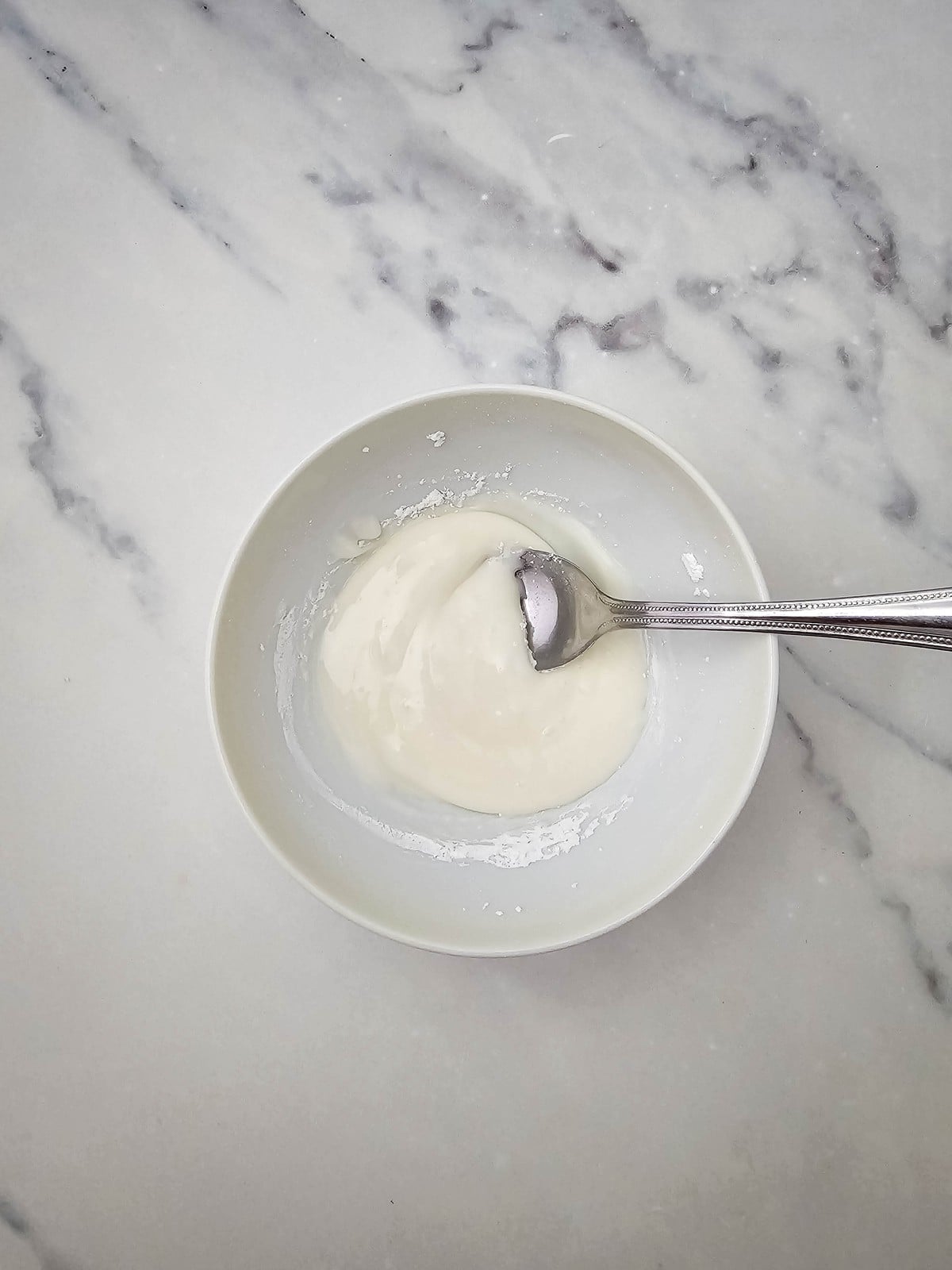 Powdered sugar glaze stirred smooth in a small bowl