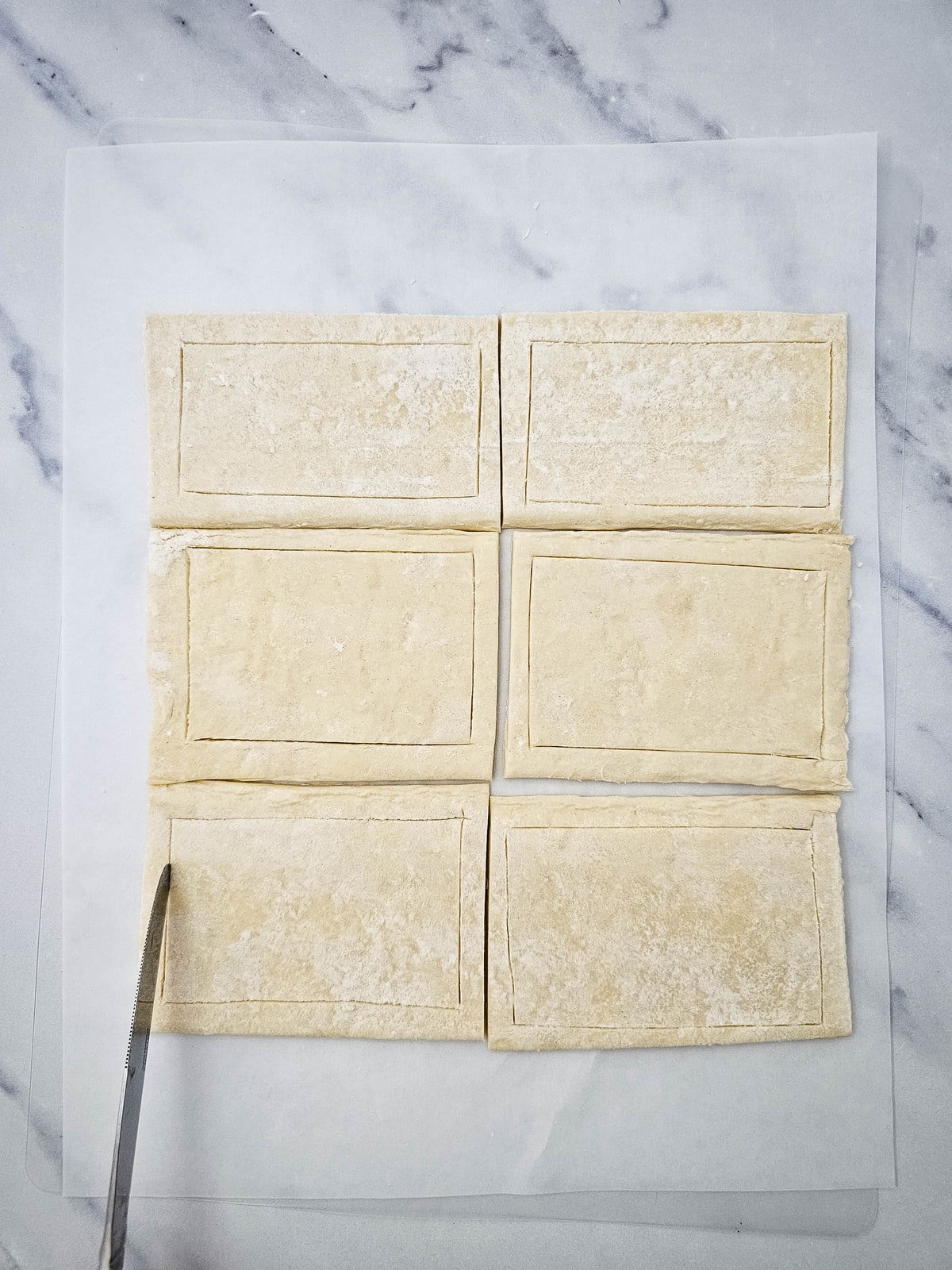 Puff pastry rectangles scored with a border for danish frames
