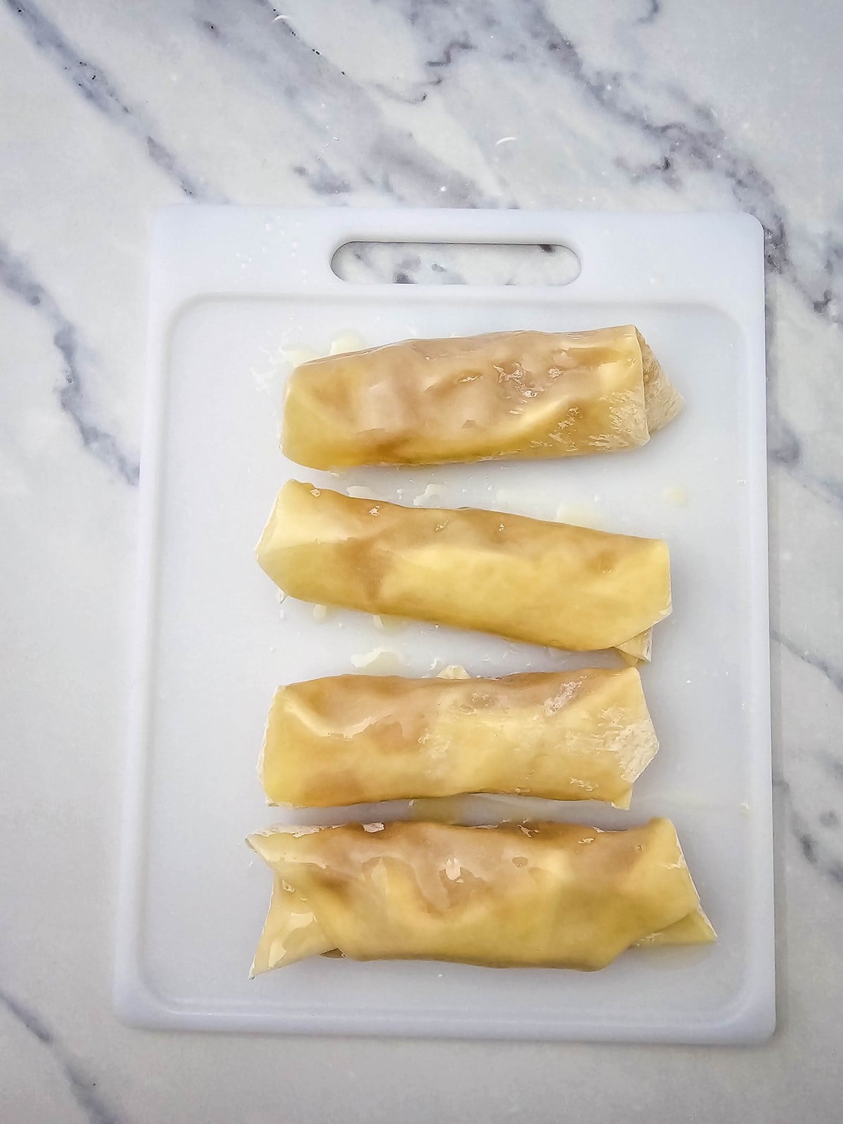 Apple pie egg rolls brushed with melted butter