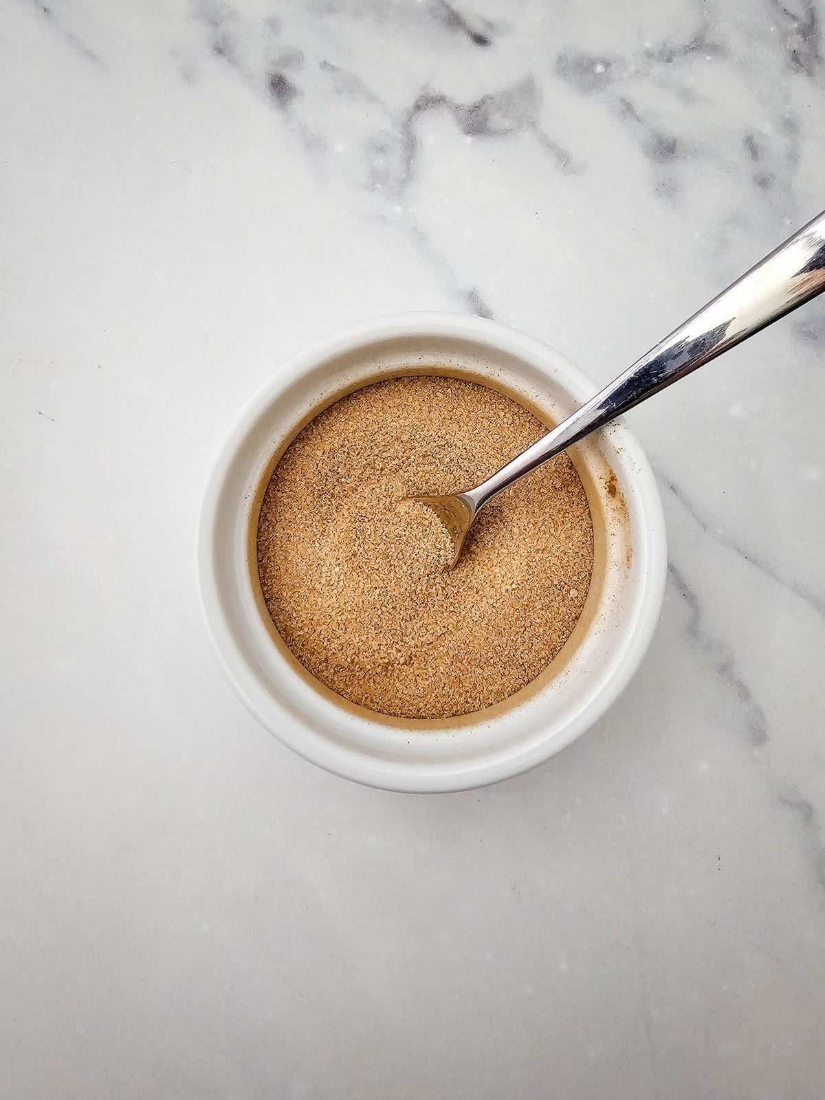 Cinnamon and sugar mixed in a small bowl