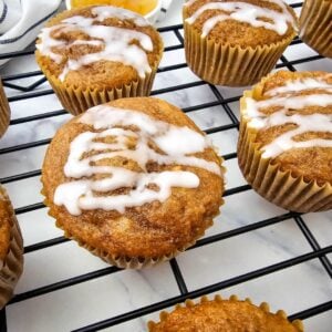 Glazed apple pie filling muffins in paper liners