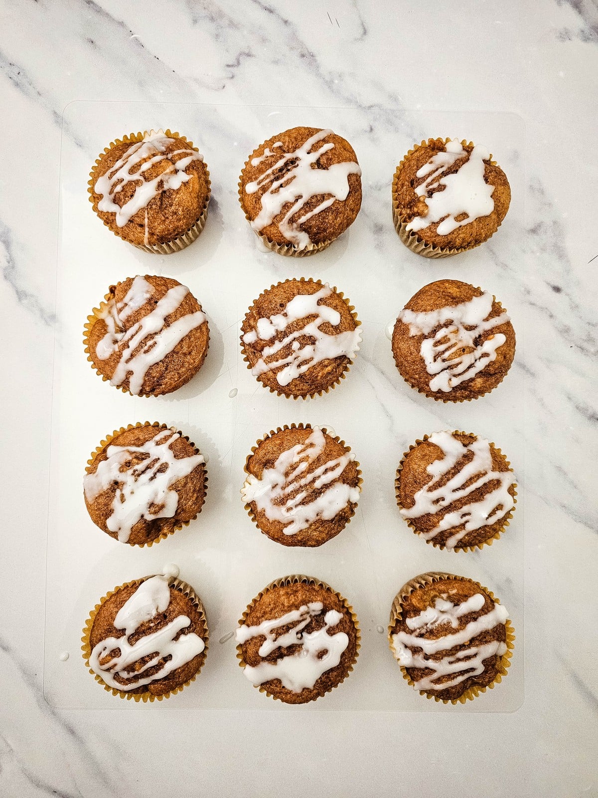 Baked apple pie filling muffins drizzled with glaze