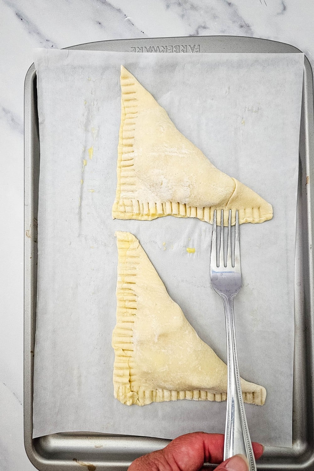 Crimping turnover edges closed with a fork