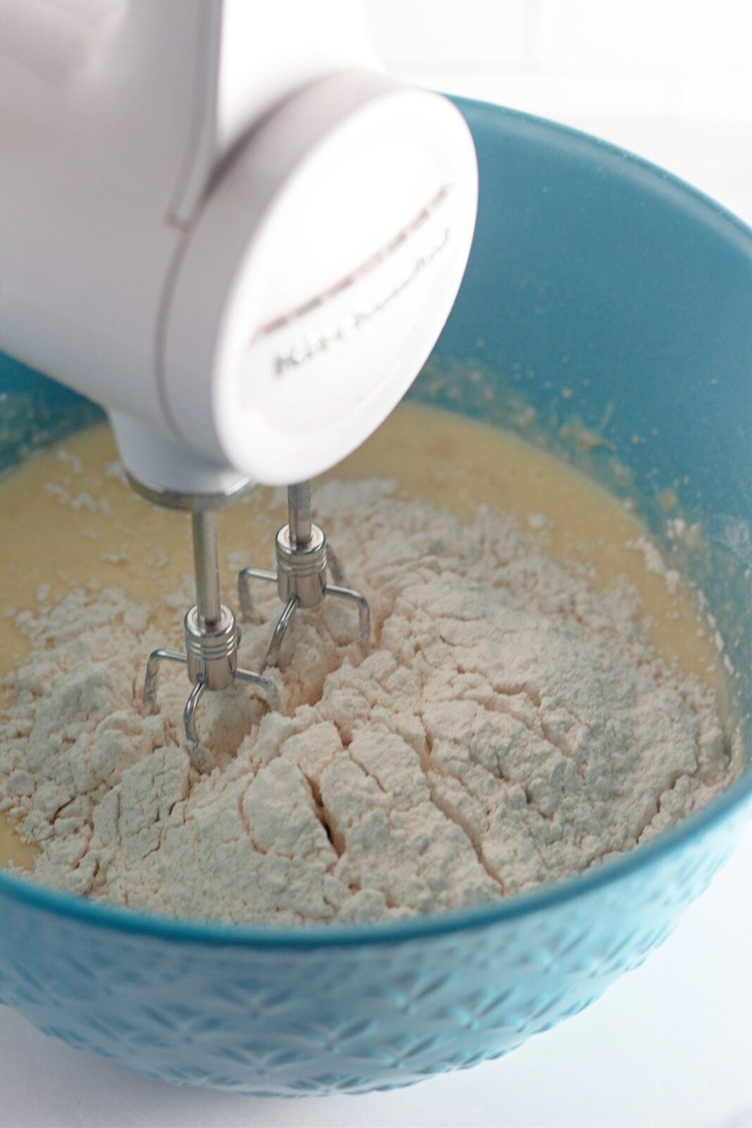 Dry flour mixture beaten into the banana batter with a hand mixer