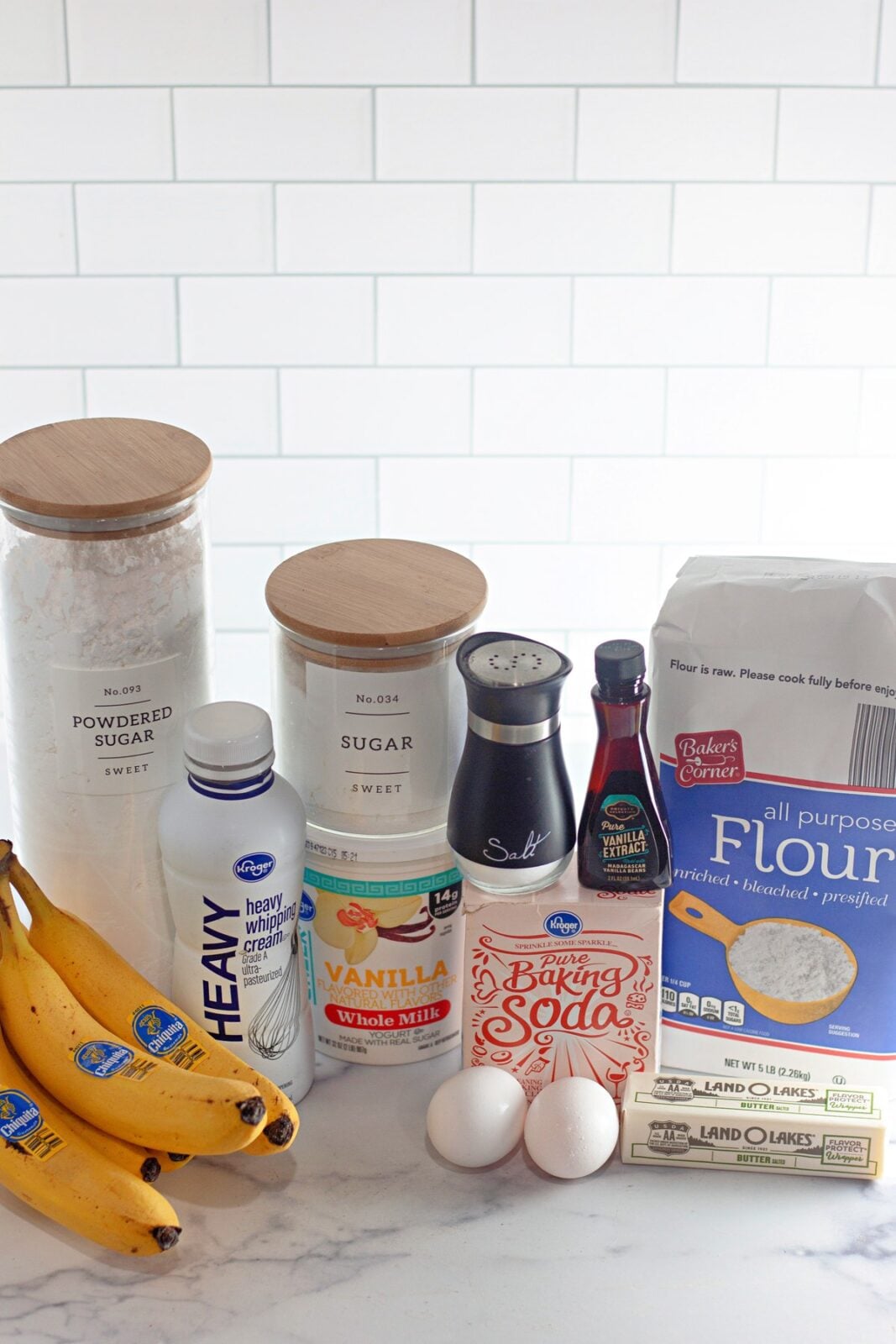 Ingredients for banana coffee cake including ripe bananas, flour, sugar, sour cream, eggs, butter, and vanilla