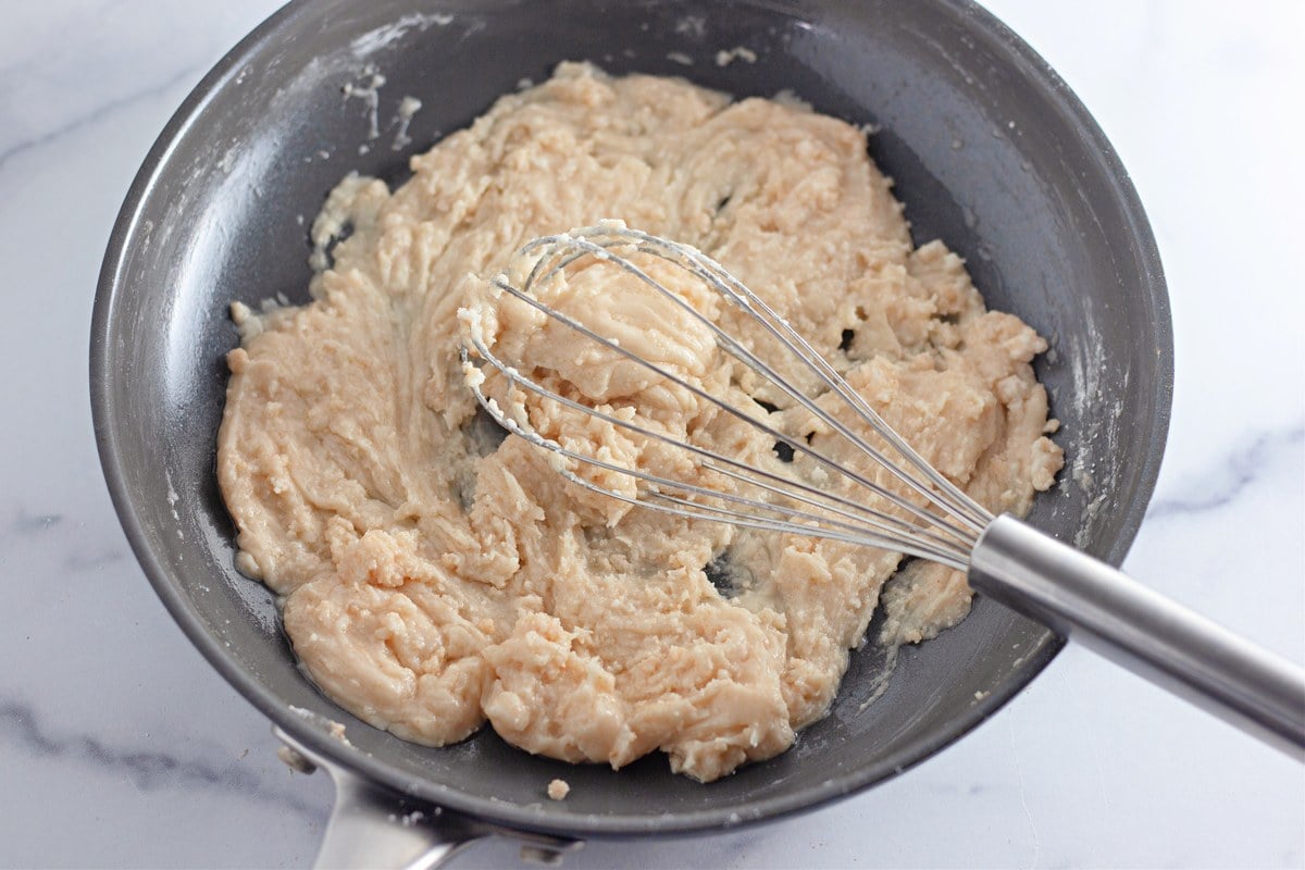 Thick and chunky browned butter frosting in the skillet before adding cream