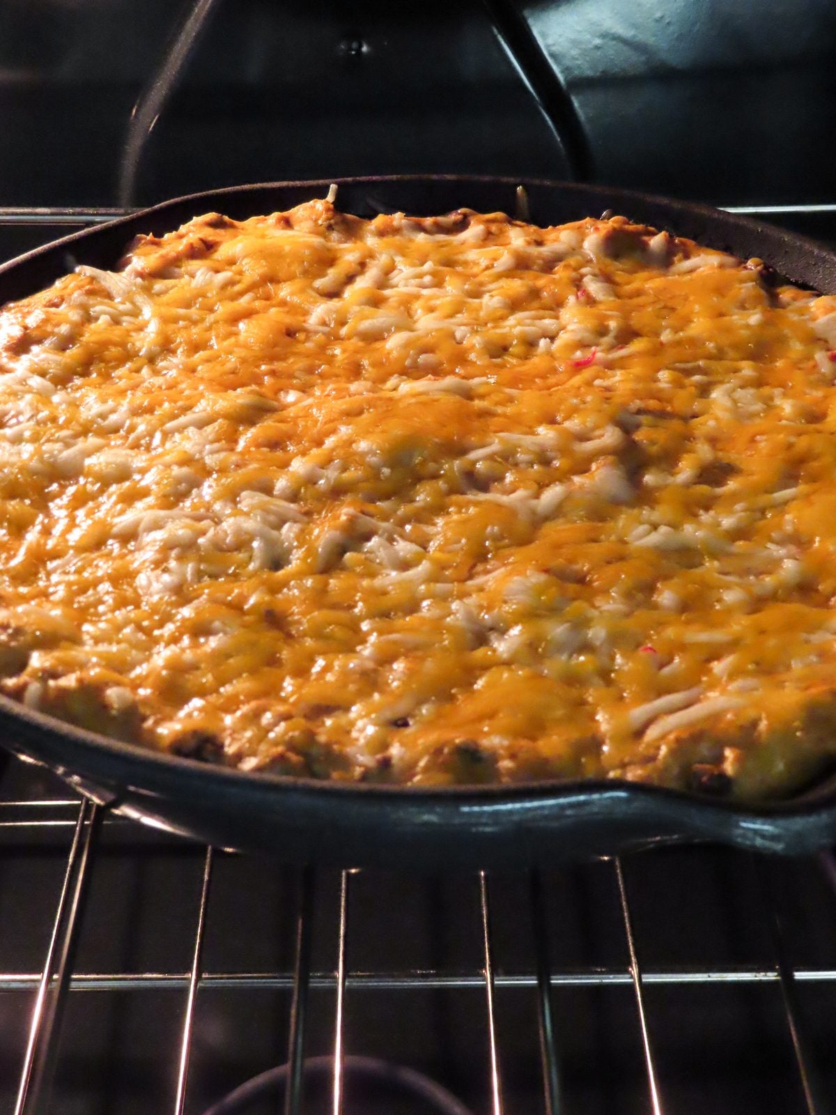 Chicken enchilada dip baking in the oven until bubbly