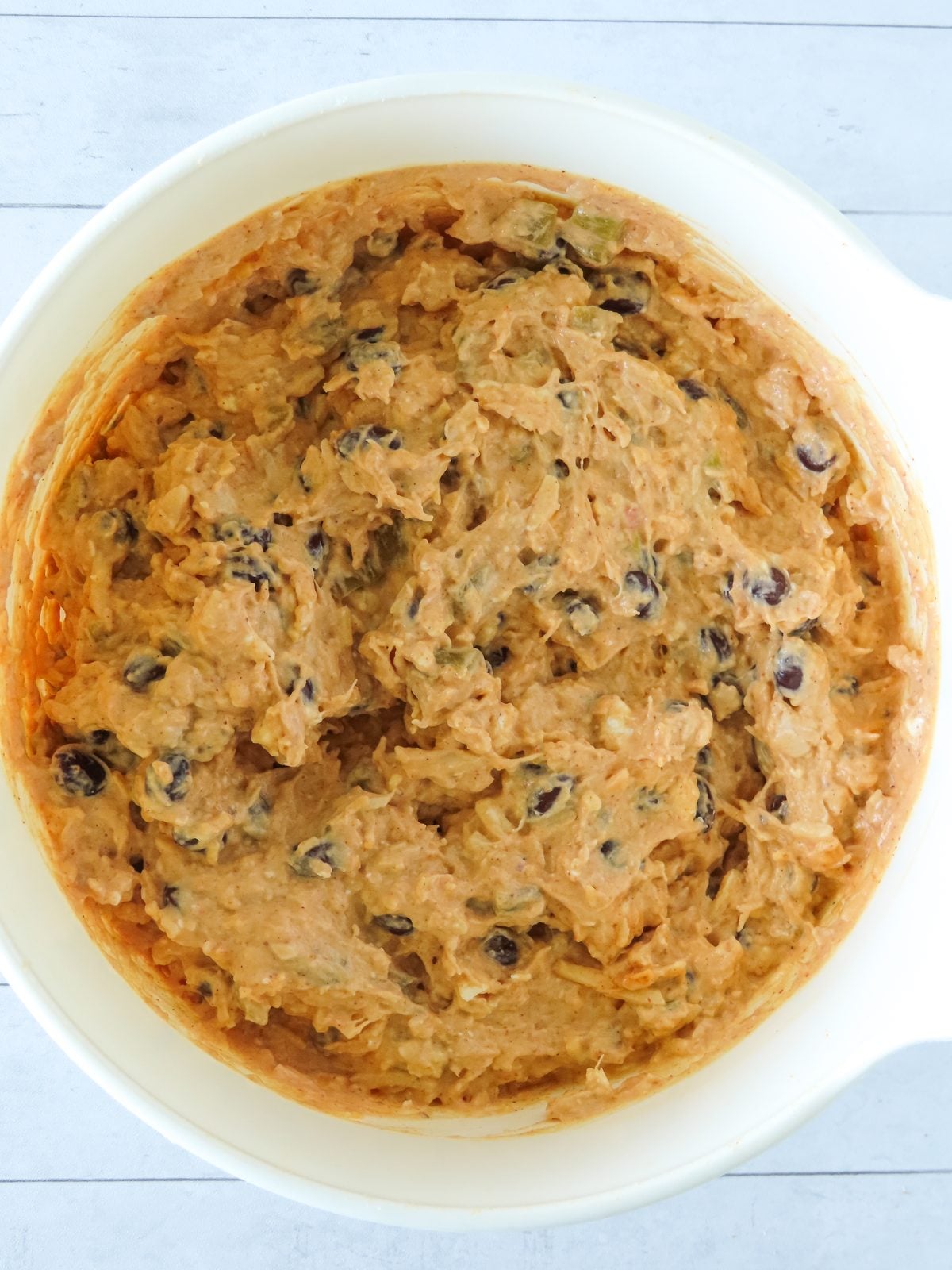 Chicken enchilada dip mixture combined in the bowl