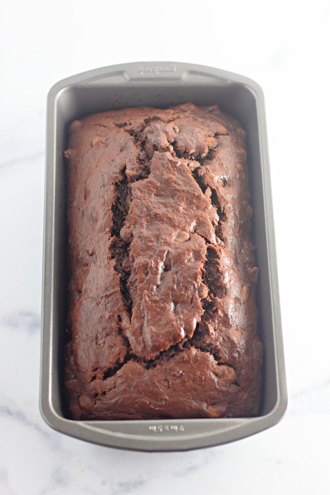 Baked chocolate banana bread loaf cooling in the pan