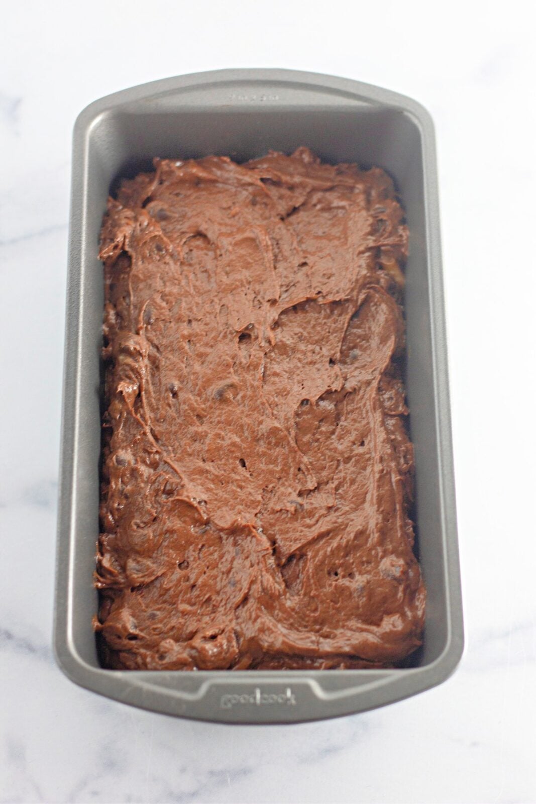 Chocolate banana bread batter spread evenly in a 9x5 loaf pan