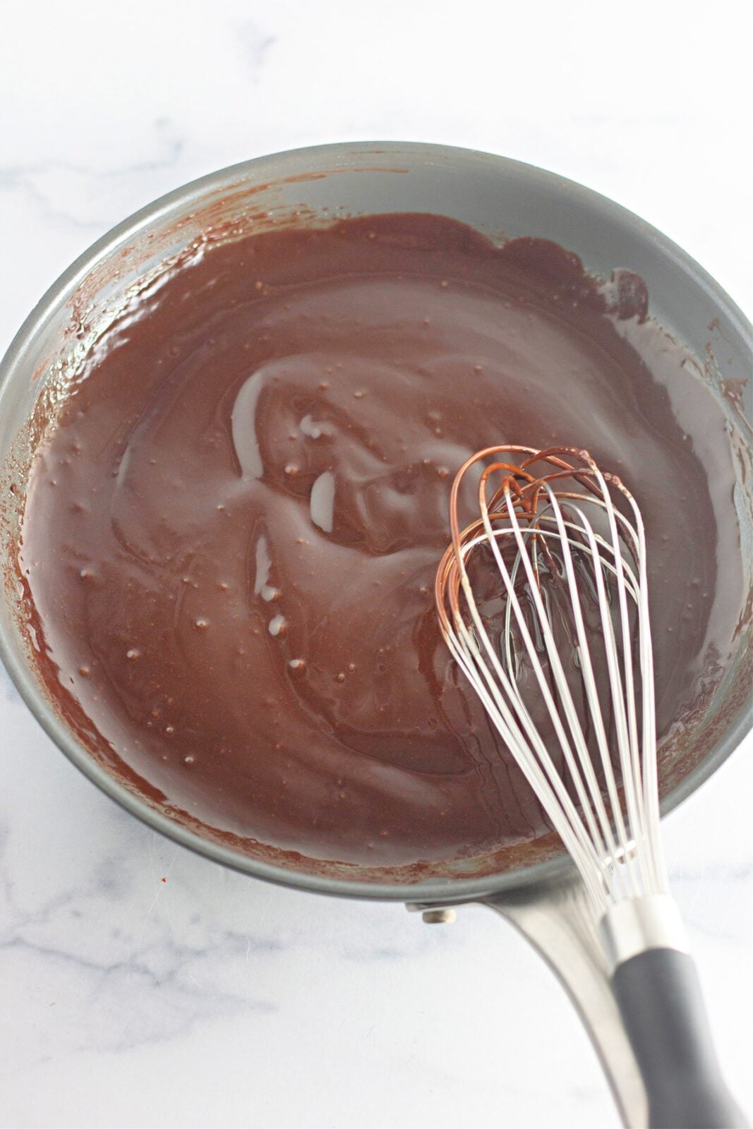 Smooth glossy chocolate fudge frosting whisked in the skillet