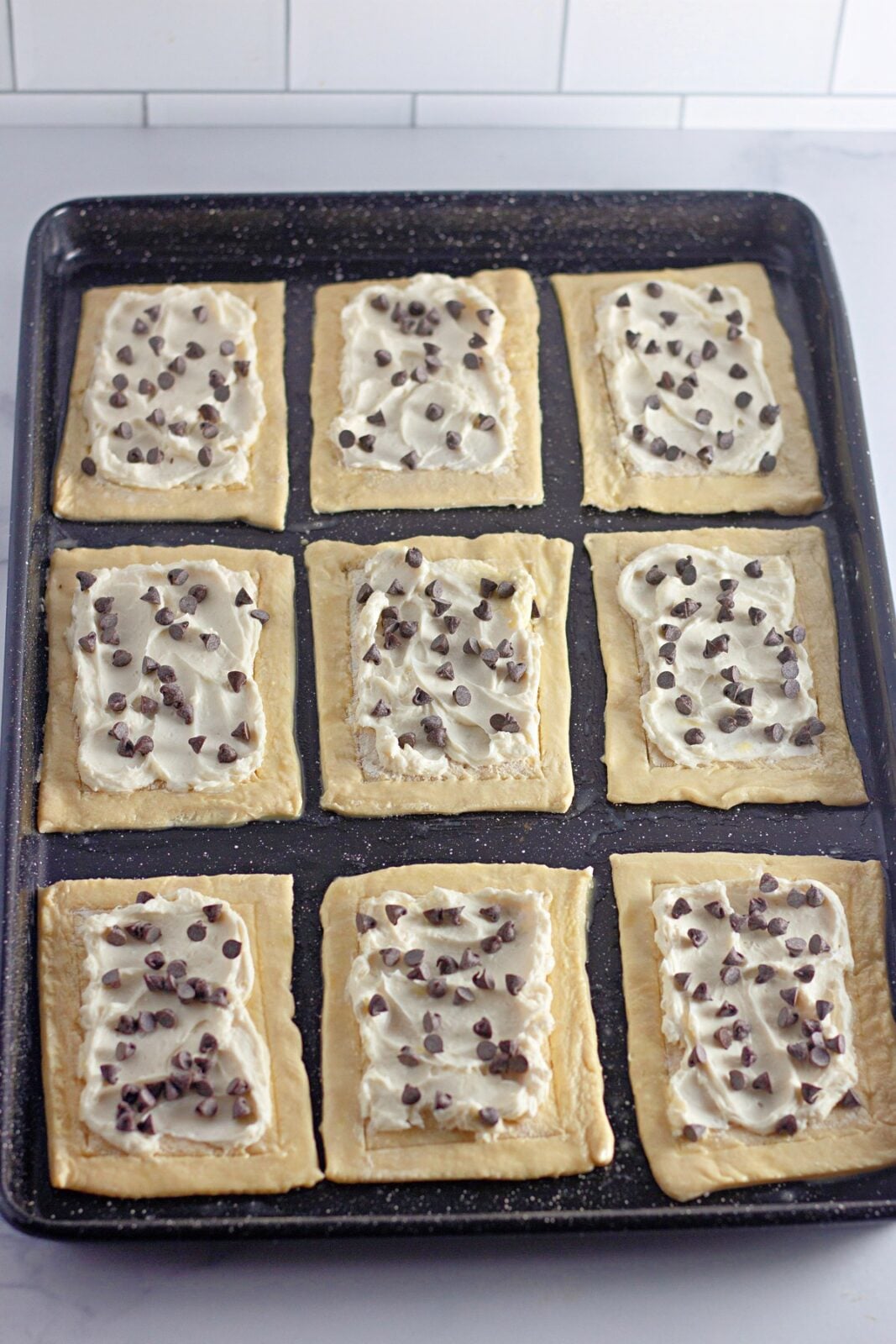 Mini chocolate chips sprinkled over the cream cheese filling on each pastry