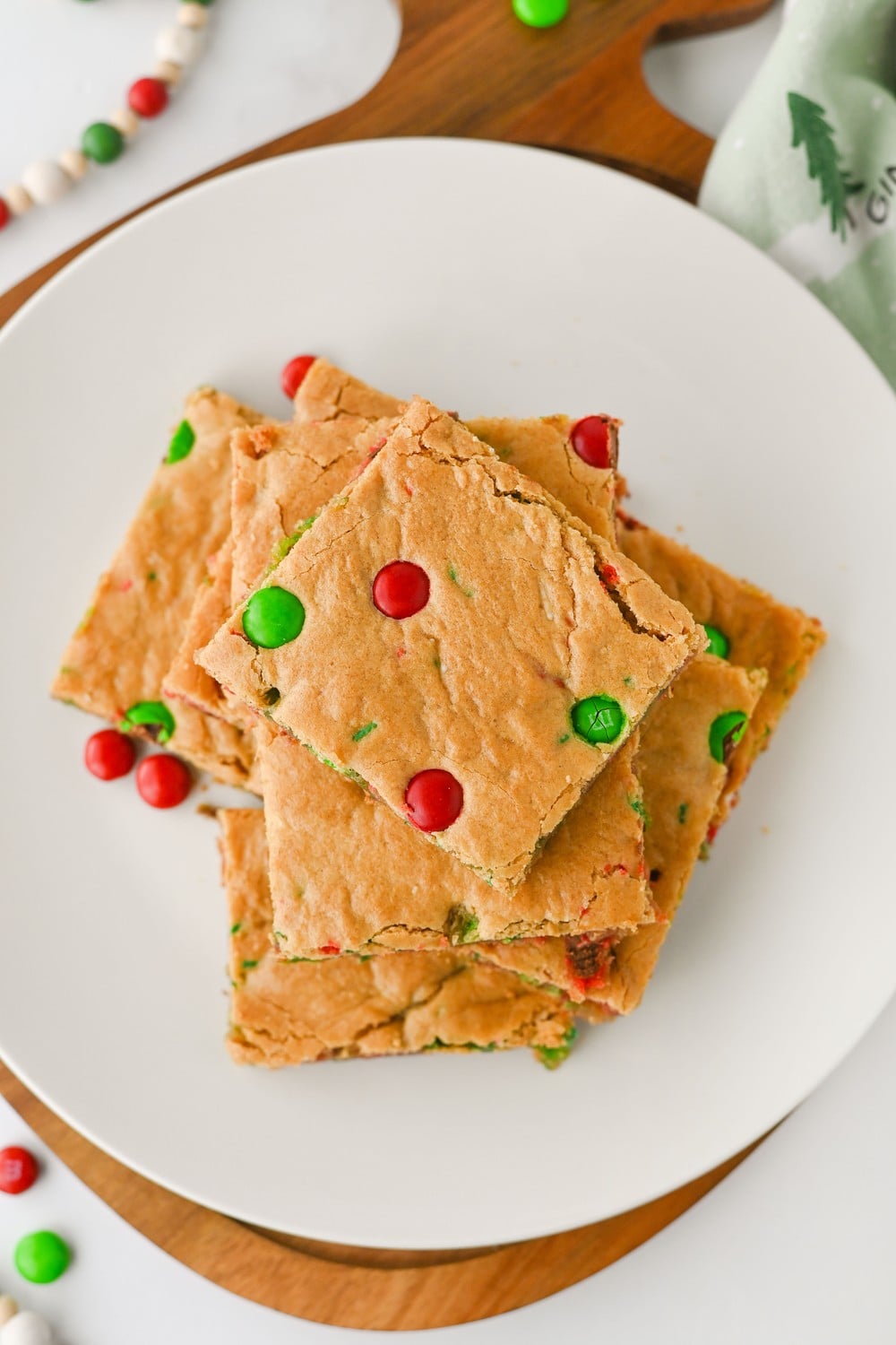 Top down view of Christmas cookie bars stacked on a white plate