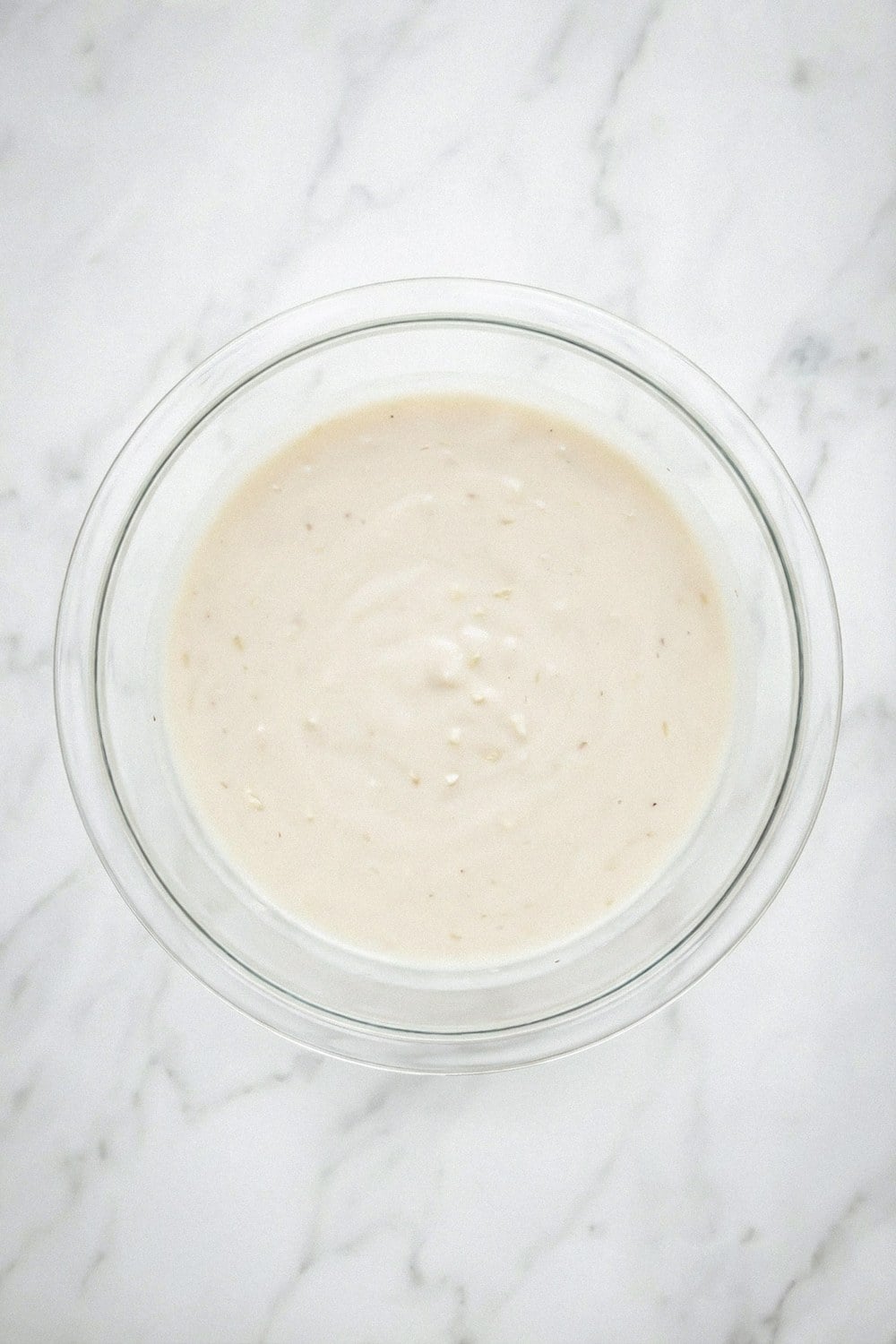 Cream of chicken soup and broth whisked together in a glass bowl