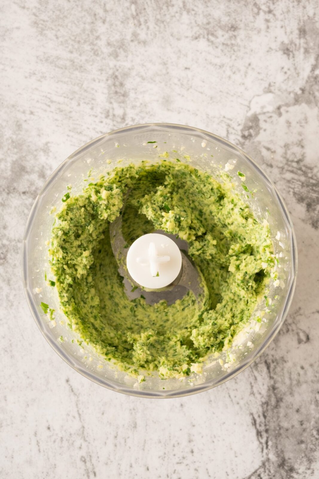 Blended green garlic herb butter in a food processor