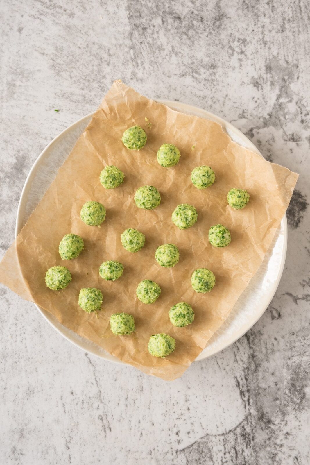 Small garlic butter balls arranged on parchment paper