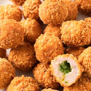 Close up of crispy panko coated chicken balls with a garlic butter filled center