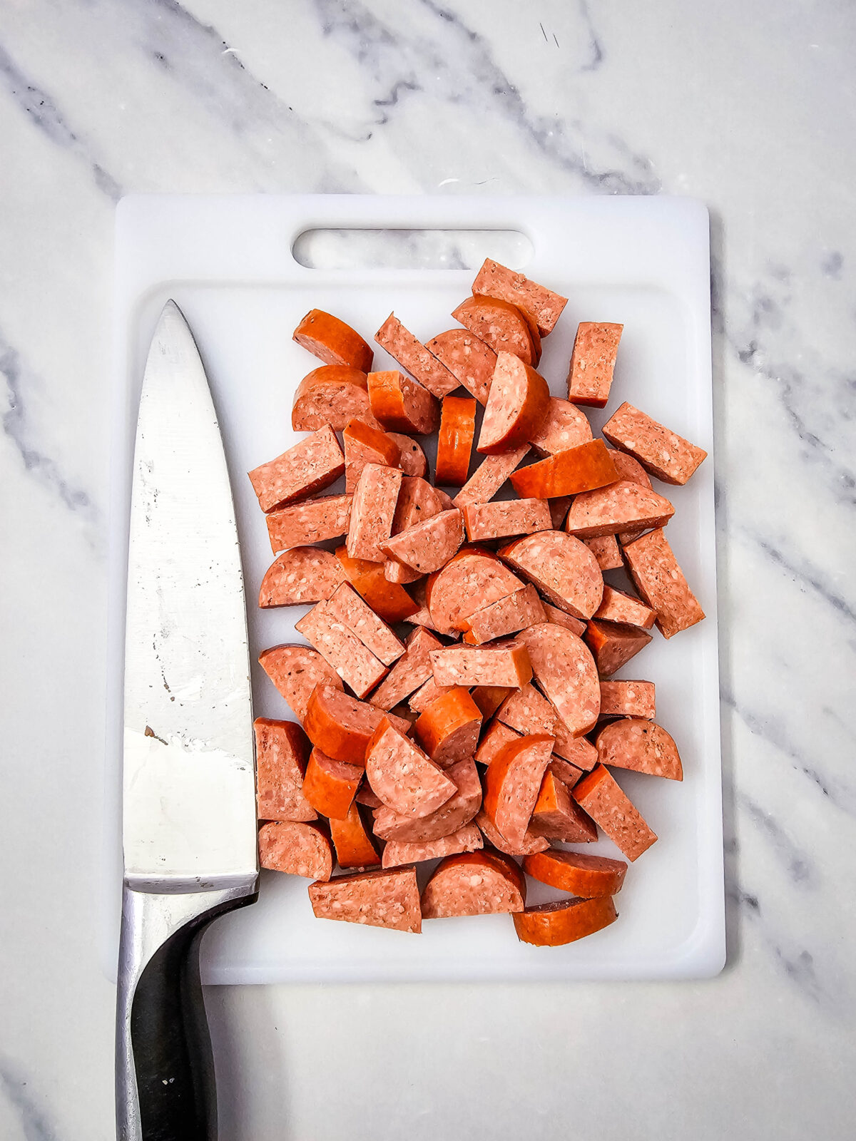 Sliced andouille sausage on a cutting board