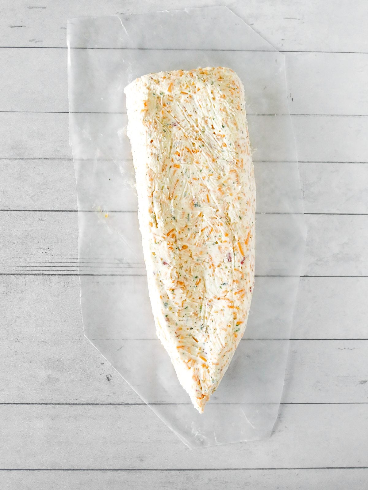 Unwrapped pencil shaped cheese ball after chilling