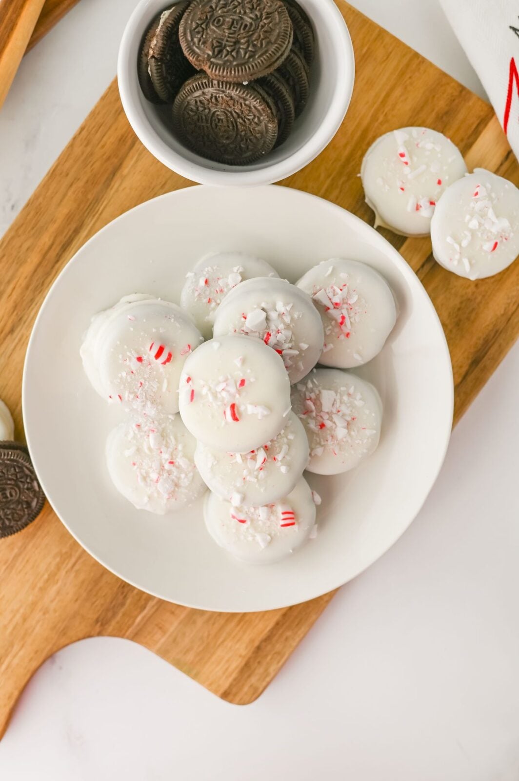 Overhead view of peppermint crunch Oreos sprinkled with crushed peppermint candy