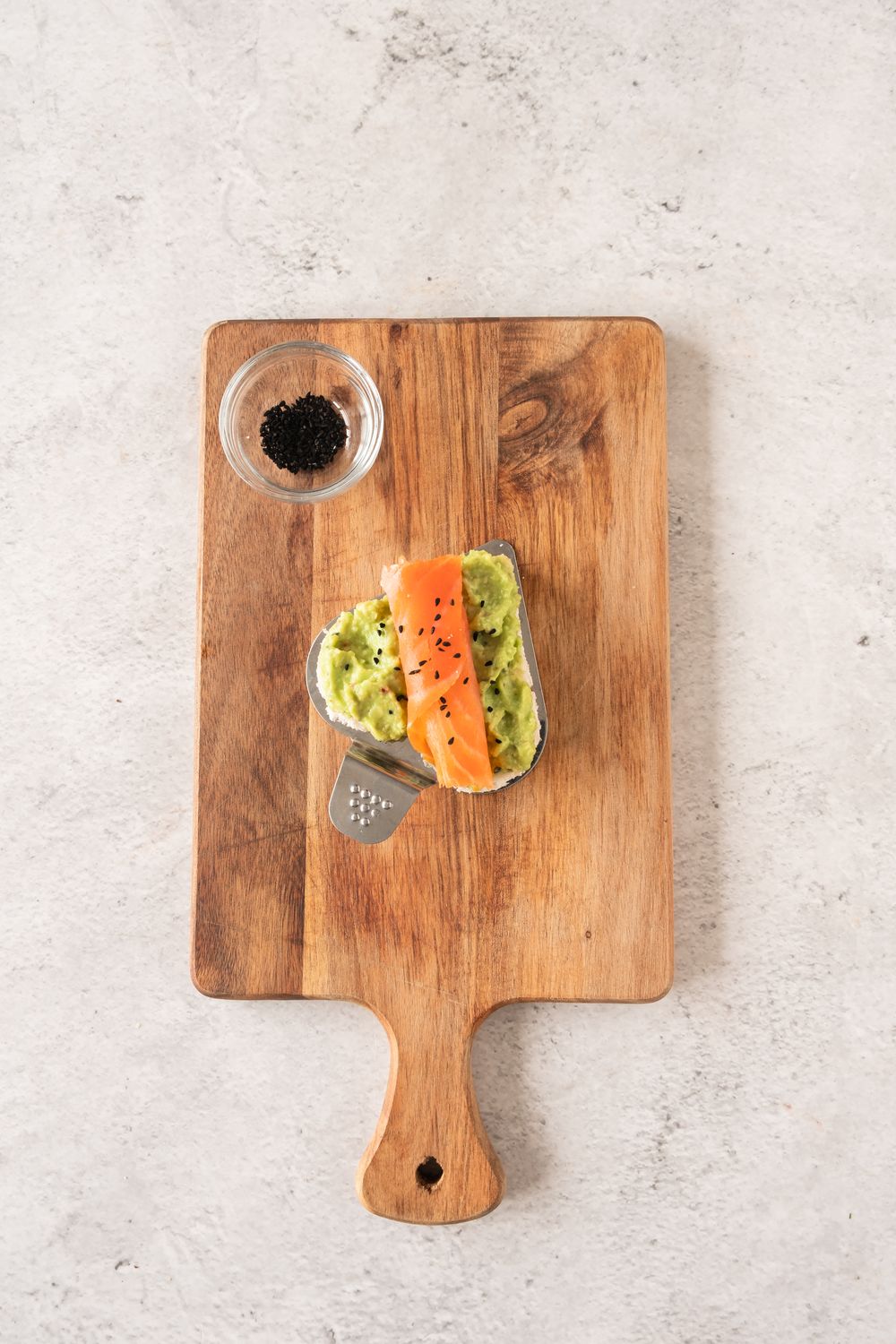 Heart shaped bread spread with avocado and topped with smoked salmon