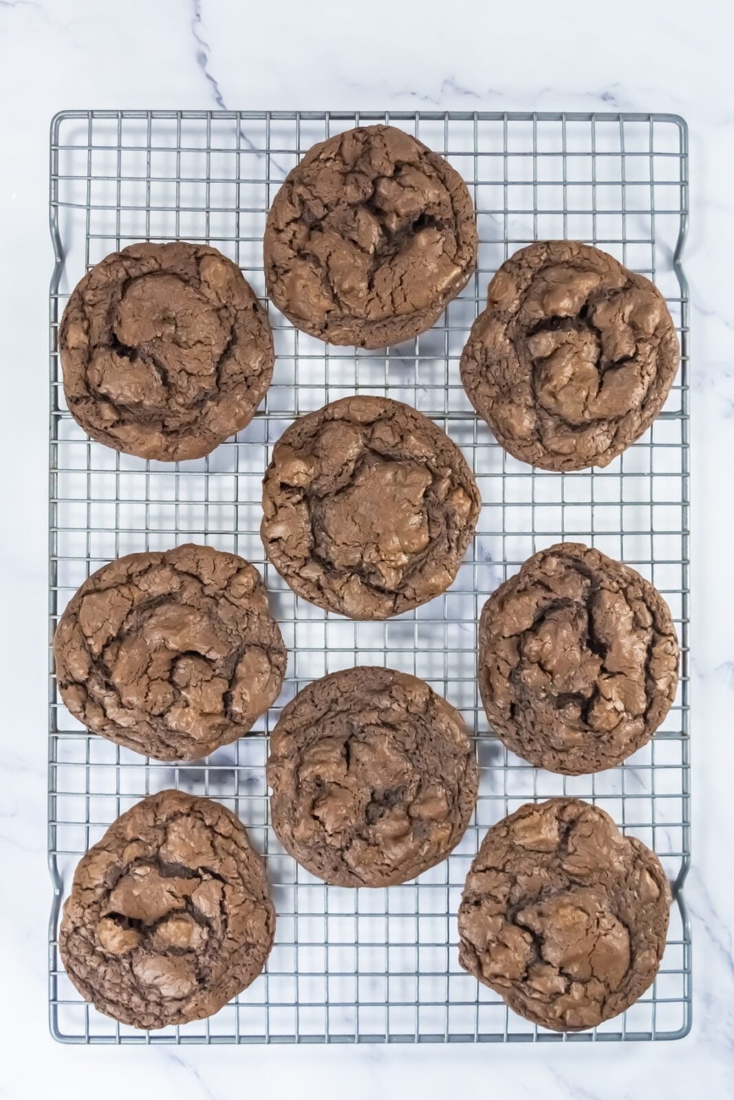 Baked brownie cookies cooling on a wire rack