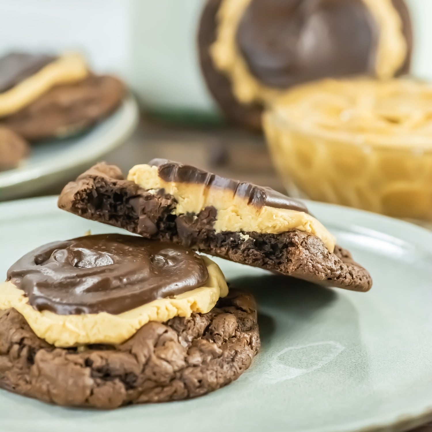 Crumbl copycat buckeye brownie cookie broken in half showing fudgy layers of peanut butter and ganache