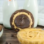 Buckeye brownie cookie with milk bottles and a bowl of peanut butter