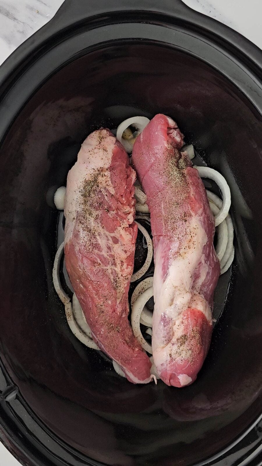 salt and pepper sprinkled over the raw tenderloins
