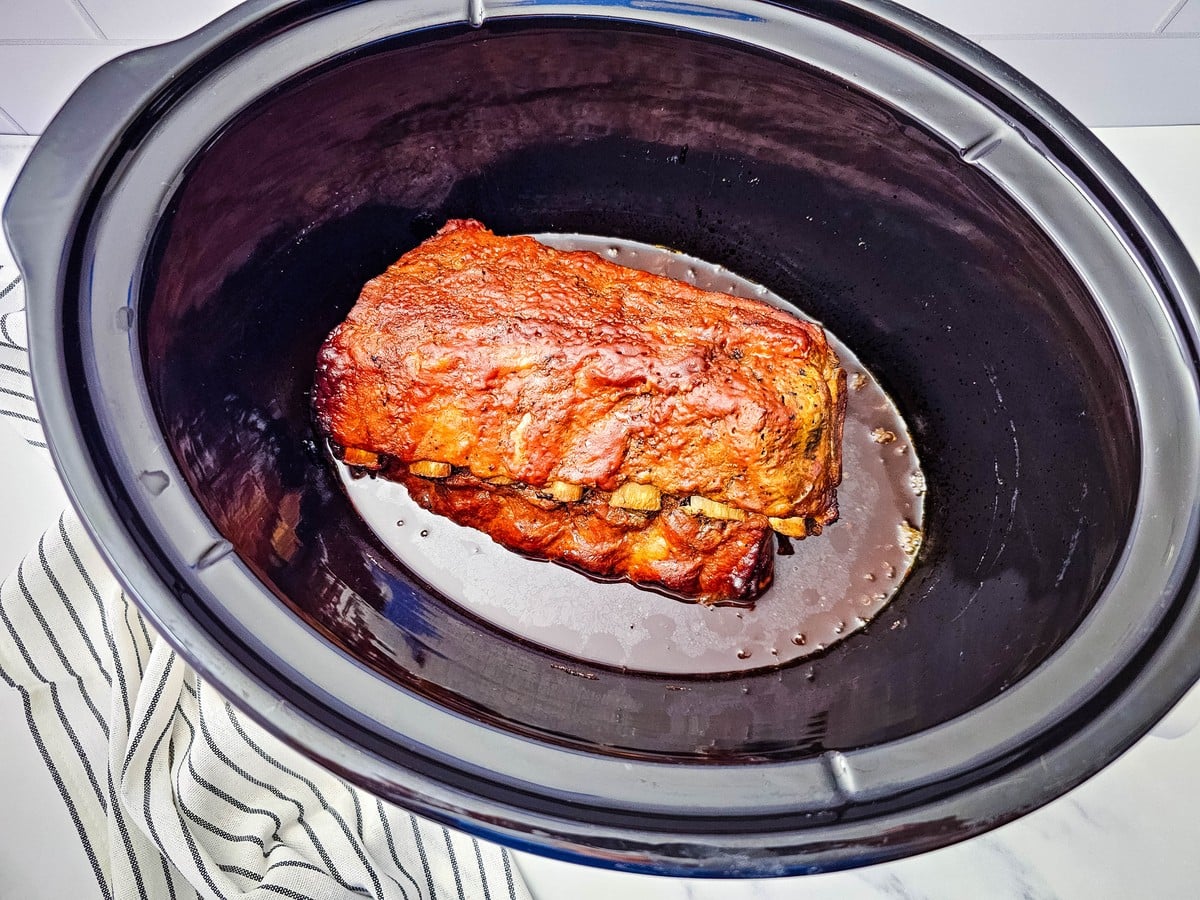Cooked crockpot ribs in the slow cooker after 8 hours on low