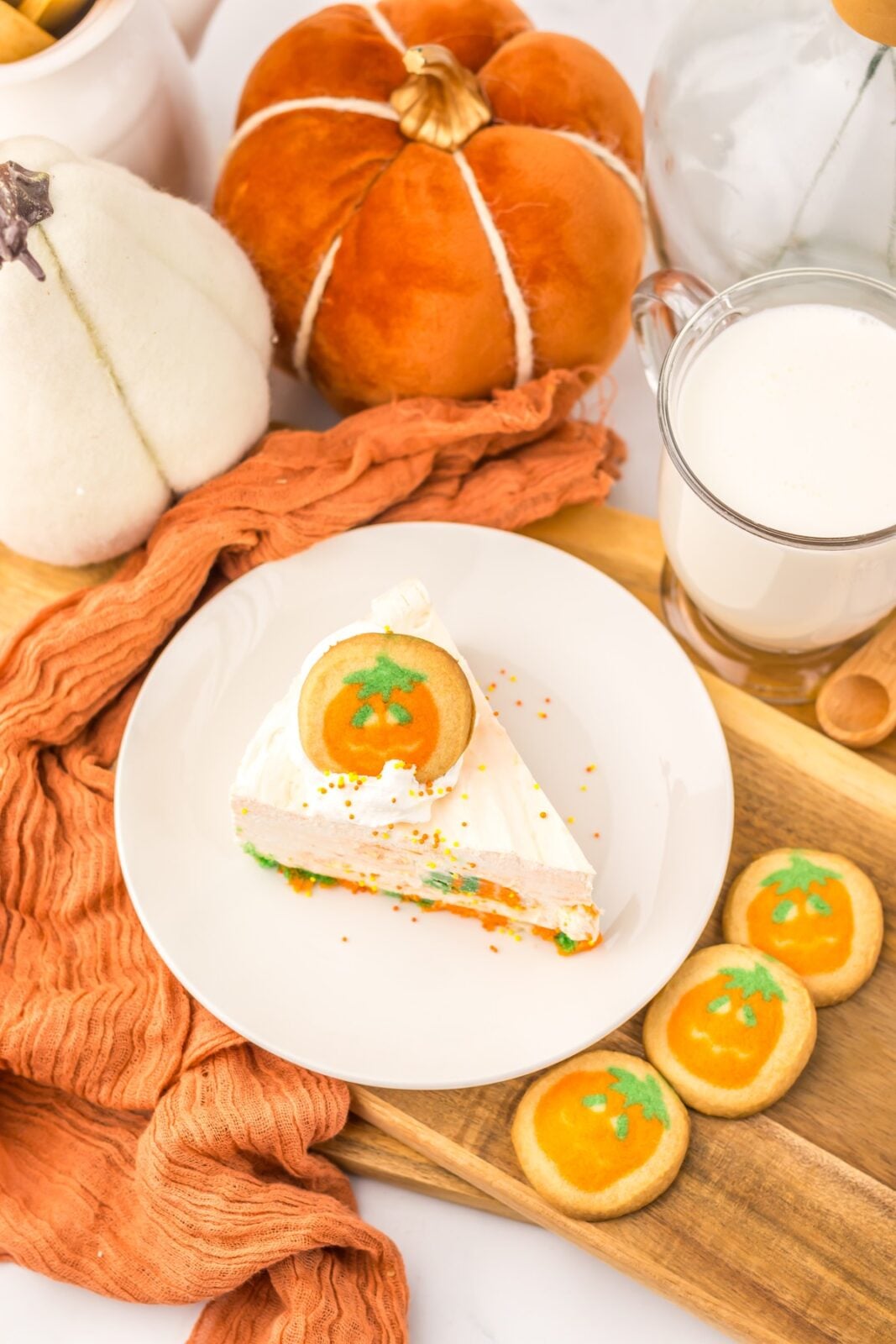 Overhead view of a no bake Halloween cheesecake slice with pumpkin cookies
