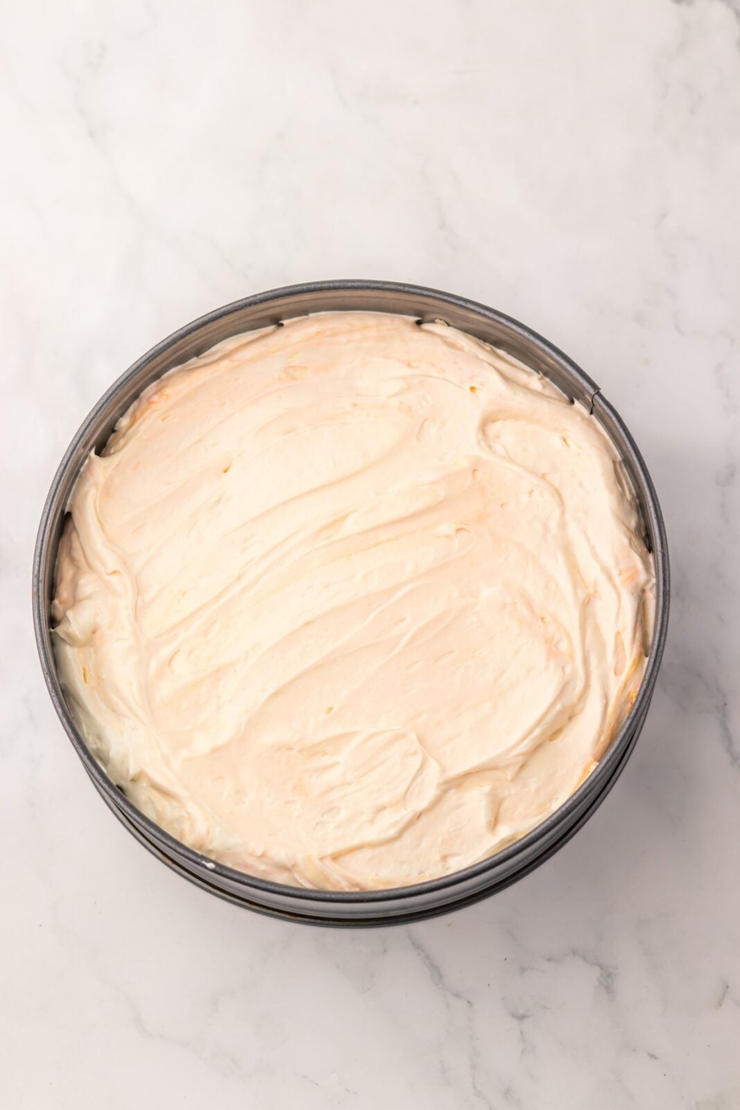Cheesecake filling smoothed over the hidden cookie layer