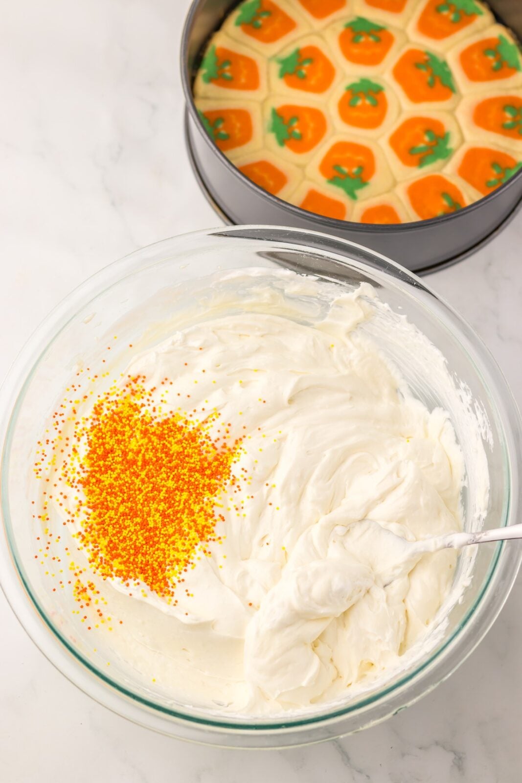 Orange and yellow Halloween sprinkles folded into cheesecake filling