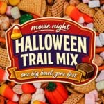 Close up of Halloween trail mix with candy corn, cereal squares, pretzels and candy pumpkins