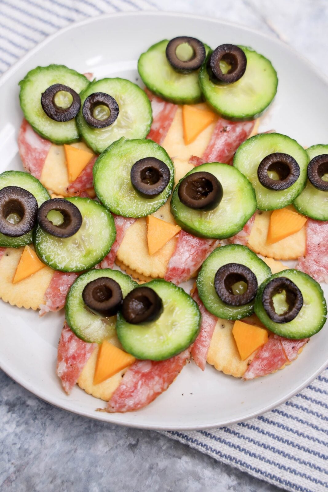 Owl crackers arranged on a white platter as a Halloween snack