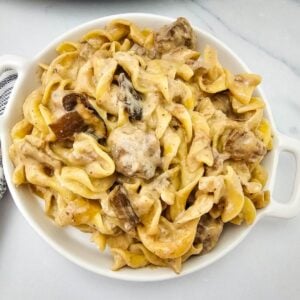 Overhead bowl of crockpot beef stroganoff with beef chunks and mushrooms