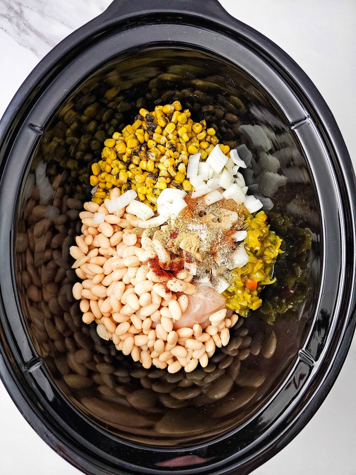 Chili powder, cumin, oregano, paprika, salt and pepper added to the crockpot